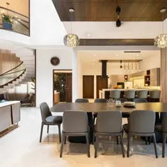An open-concept layout where the dining area, living room, and kitchen all flow into one another. The large dining table is perfect for hosting, and the cohesive design makes the entire space feel unified and expansive.