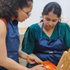 I believe in personalized guidance. Here, one of our experienced instructors provides one-on-one feedback during a workshop, ensuring every student understands the process and feels confident in their work.