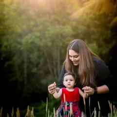 A tender moment between a mother and her daughter, captured in the beautiful soft light of an outdoor setting. We guide our clients into natural poses that highlight their connection.