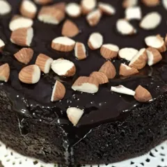 A closer look at the glossy chocolate ganache and toasted almonds on my healthy chocolate cake. It's the ideal guilt-free treat for your next celebration.