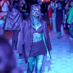 A model walking the runway during our Halloween fashion show, 'THE RED DANCE' at JULIET BLR. We combine music with fashion for a unique experience.