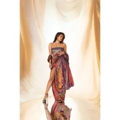 A stunning studio portrait of Priyanka Chopra. The flowing, colorful garment and the reflective floor create a beautiful, ethereal image that highlights her grace and star power.