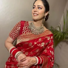 A timeless look for any festive occasion. This client is radiant in a classic red Banarasi silk saree, paired with a heavy rental Polki necklace that elevates the entire outfit.