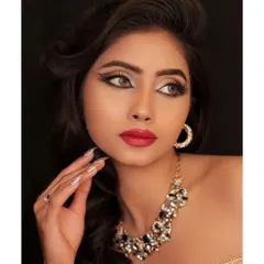 A beauty shot focusing on the model's flawless skin and elegant pose. The lighting is soft and flattering.