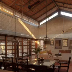 The heart of the home is this double height living and dining space. Clerestory windows and large wooden doors flood the area with natural light, highlighting the raw texture of the stabilized mud block walls and the intricate patterns of the Athangudi tile flooring.