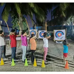 This image captures the focus of our students, both young and old, as they take aim during a group training session.