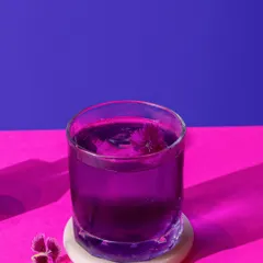 A deep purple cocktail against a vibrant pink and purple background. This minimalist, colour-blocked style is modern, bold, and perfect for a trendy bar menu.