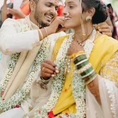 A sweet, candid moment during Pratik and Yamini's Maharashtrian wedding. The groom feeding the bride is a classic ritual, but their shared smiles make it a unique and personal memory.