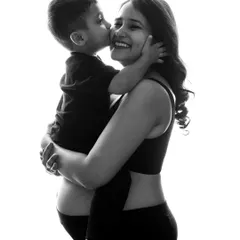 A sweet kiss for mom from her son during their maternity session. This black and white photo beautifully captures the love and excitement of a growing family.