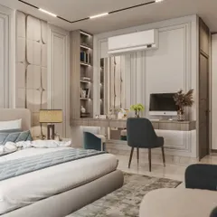 This bedroom shows how we integrate multiple functions into one space. A custom-built unit combines a study desk and vanity area with shelving, seamlessly connected to the room's wall paneling and wardrobe design.