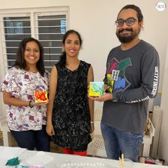 The happy result of a creative session! This couple, along with a friend, proudly displays the coasters they made during a private workshop at my studio.