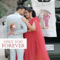 A unique 'save the date' concept, with a poster hanging from a car as the couple shares a romantic moment at dusk.