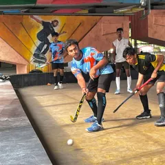A player prepares to receive a pass during a practice match. Notice the low, athletic stance required for rink hockey to maintain balance and control.