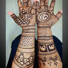 A clear view of the elephant motifs on the forearm, combined with personalized initials and interlocking rings for a complete story.