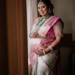 We specialize in traditional maternity photoshoots, celebrating cultural heritage with grace. This portrait captures the expectant mother's serene glow, beautifully framed by natural window light that highlights the intricate details of her silk saree and jewellery.