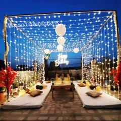 I love transforming terraces into magical spaces for intimate celebrations. Here, I created a canopy of fairy lights and hung paper lanterns for a cozy birthday dinner, using low seating with comfortable floor cushions to create a relaxed and stylish atmosphere.
