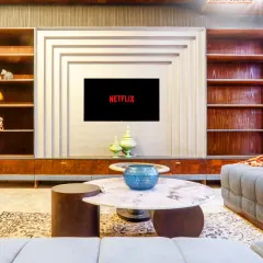 This entertainment unit is more than just a place for the TV; it's an architectural feature. The layered design and built-in shelving create a focal point in the room, blending storage and style perfectly.