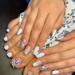 Evil eye, but make it couture. This matching manicure and pedicure set features a mix of solid white nails and accent nails with an all-over evil eye pattern.