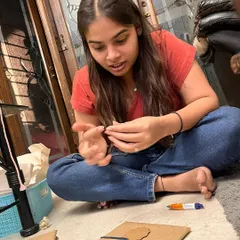 It's all in the details! Here I am, sitting on the floor and hand-tying the packaging for a bulk order. Every single item gets personal attention.