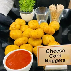 Our Cheese Corn Nuggets are a hit with guests of all ages. These crispy bites are filled with a creamy mixture of cheese and corn, served with ketchup for dipping.