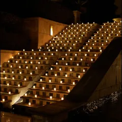 The grand staircase, illuminated by hundreds of candles, creating a breathtaking and dramatic pathway for the all-white Sufi night.