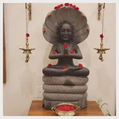 The statue of Maharshi Patanjali, adorned with flowers. We honor him as the father of modern yoga, and his presence brings a deep sense of reverence and dedication to our space.