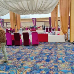 This image shows the arrangement of both lounge and standard seating across a large, carpeted event space.