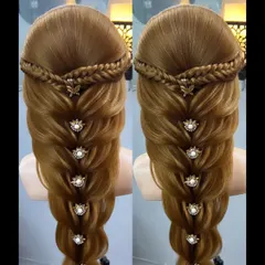 A stunningly intricate braid look, decorated with beautiful floral pins. This style combines multiple braiding techniques.