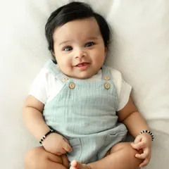 A relaxed and happy baby looking right at the camera. Simple, classic portraits like this are timeless and beautifully showcase your baby's features.