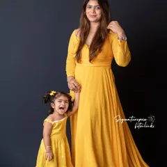 The pure joy of childhood captured in a candid moment with mom. The daughter's laughter and the mother's loving gaze make this a heartwarming "Mom & Me" portrait.