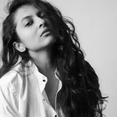 A simple portrait in a white shirt, with my hair falling naturally. This shot from the 'Dans Mon Boudoir' series is about capturing an unfiltered and relaxed moment.