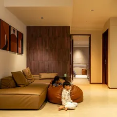 We design spaces for real life. Here, the informal family lounge with a low-profile sectional sofa and beanbags is a comfortable and playful area for the children.