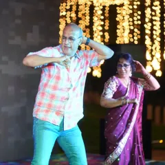 Parents grooving on the dance floor in casual attire. This shows that the fun doesn't have to be limited to the main event; we can bring the party to any pre-wedding gathering.