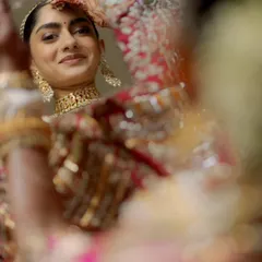A beautiful reflection of the bride as she gets ready. This intimate shot captures her happy anticipation and the quiet moments of transformation before she walks down the aisle.