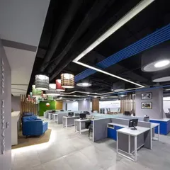 Here is a look at a complete open-plan office I designed. The layout includes modular workstations for focused tasks, a comfortable breakout area with the blue sofa for informal meetings, and carefully planned lighting to create a productive atmosphere.