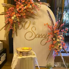 Celebrating 60 years in style with our "60 & Sassy" setup. This elegant design features a beautiful arched backdrop adorned with lush, vibrant floral arrangements and pampas grass, creating a sophisticated and picture-perfect spot for a milestone birthday bash.