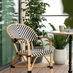 A close-up of the stylish rattan bistro chair, perfect for creating a Parisian cafe vibe on a home balcony.