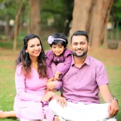 A relaxed family portrait taken in a park. Sitting together on the grass with natural light creates a warm and authentic feel that is perfect for capturing genuine family connections.
