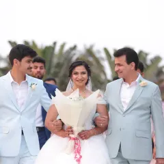 A heartwarming moment as the bride walks down the aisle for her Christian wedding. Her look is all about soft, romantic elegance, with a delicate updo and natural makeup that enhances her glow without overpowering her beautiful white gown.