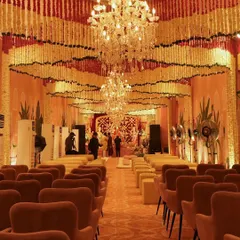 Another view of the magnificent hall, showing the aisle lined with comfortable seating, leading towards the main stage. The floral ceiling creates a breathtaking canopy of color and fragrance.