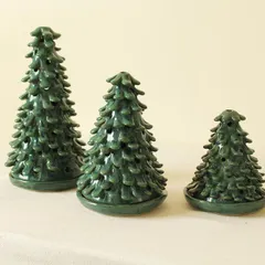 This set of three Coniferous Christmas tree luminaries comes in varying heights, perfect for creating a festive centerpiece on your holiday table.