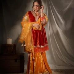 The full-length view of this velvet sharara set shows its beautiful movement and rich color combination. It's a perfect choice for a winter wedding or a grand Diwali celebration.