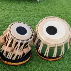 A high-quality professional tabla set with a green-tinted bayan, showcasing the unique aesthetic options we offer. You can book your own custom, high-quality tabla through our academy.