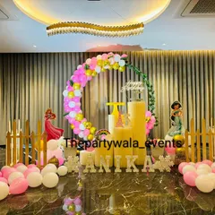 A wide view of a princess party setup in a large hall. The balloon arch and props create a beautiful focal point on the marble floor, showing how I can transform any space.