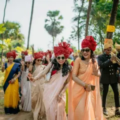 The energy of the baraat is infectious. Here, guests are seen dancing and celebrating the groom's arrival.