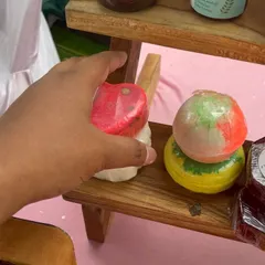 A customer picking out a heart-shaped bath bomb at my stall. I love making them in different shapes and colours to make bath time extra special.