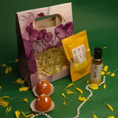 This mini Diwali hamper combines handmade treasures for a complete festive ritual. It includes two ladoo-shaped candles, a packet of natural Ubtan powder, and a bottle of traditional Abhyanga oil.