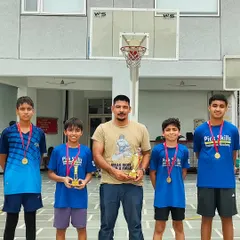 Success is a team effort. Here I am with our victorious junior boys' team, celebrating their first-place finish. Each player contributed to this win, showcasing the results of our dedicated tournament preparation program.