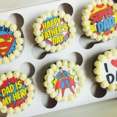 Another angle of the superhero-themed Father's Day cupcakes, showing how the six different designs create a cohesive and thoughtful gift box.