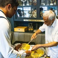 A player being served a meal in the clubhouse. Proper nutrition and rest are as important as practice, and we ensure our players are well looked after.